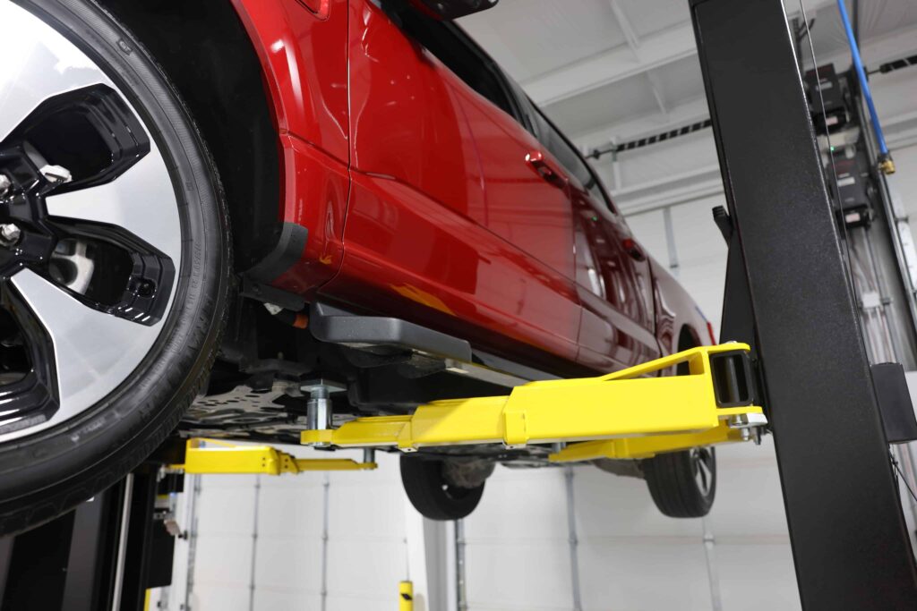 A closeup on the lift arms of a Challenger CL-12 lift
